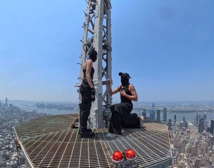 Two people scale Empire State Building and unfurl peace banner in dramatic New York stunt