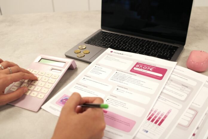 Person reviewing a handwritten budget and savings plan at a table
